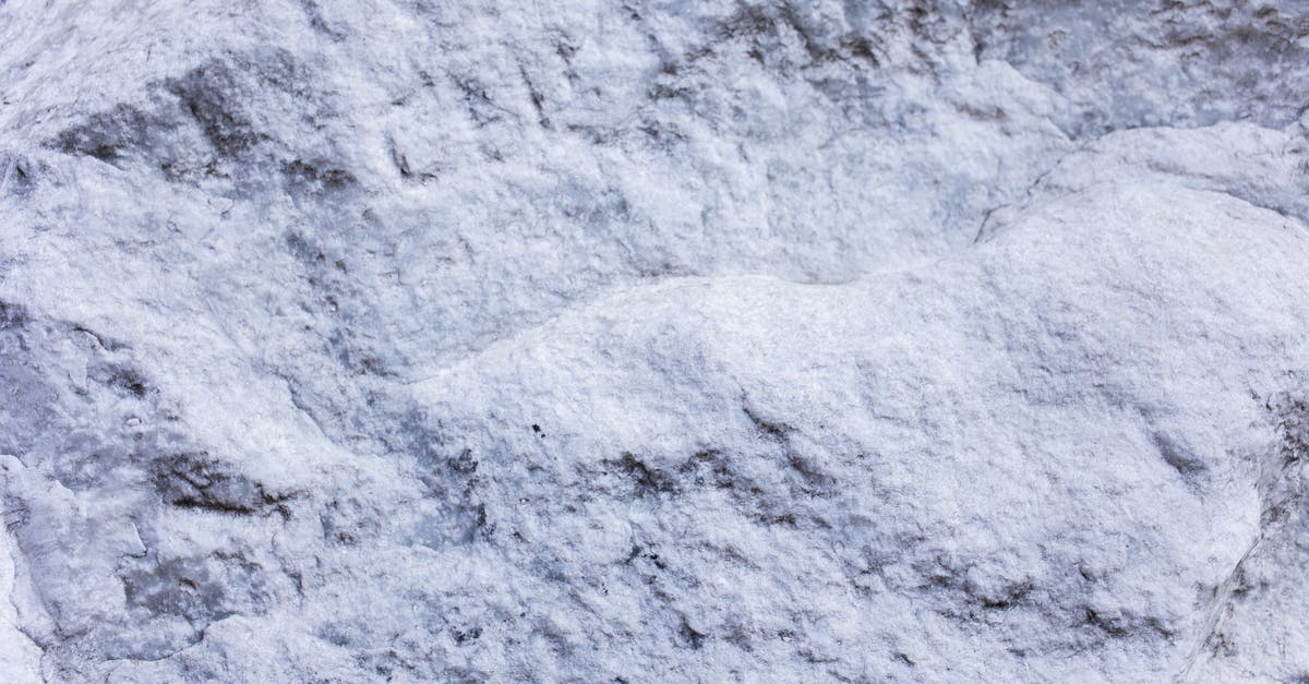 Where in Norway are these massive boulders? - From above of abstract background of white cracked surface rocky stone with rough texture