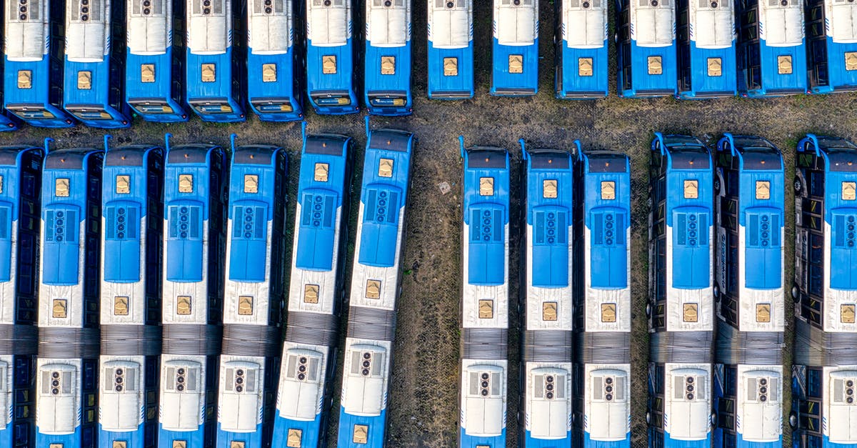 Where in Stockholm do buses leaving for Serbia depart from? - Parked White-and-blue Bus