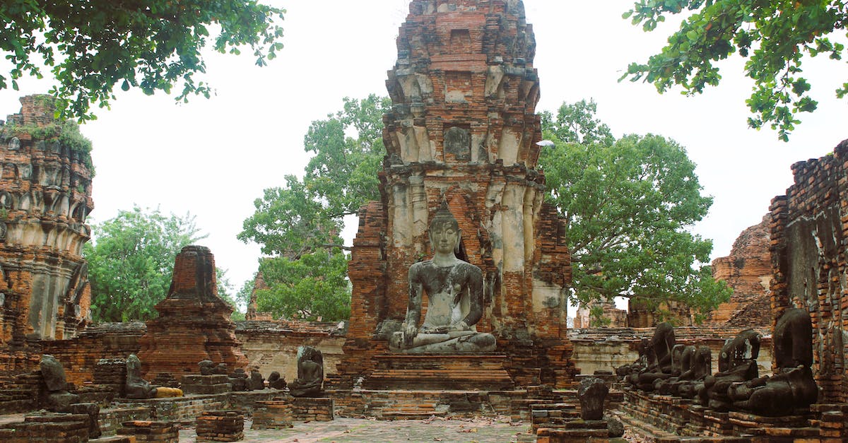 Where in Thailand should I be cautious about malaria? - Gray Concrete Statue Near Green Trees