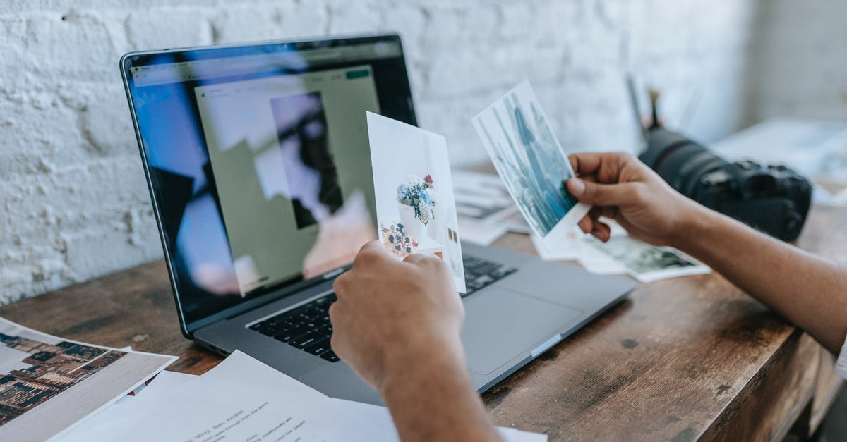 Where is the background photo used by Office 365 taken? - Crop unrecognizable man choosing photos and working on laptop