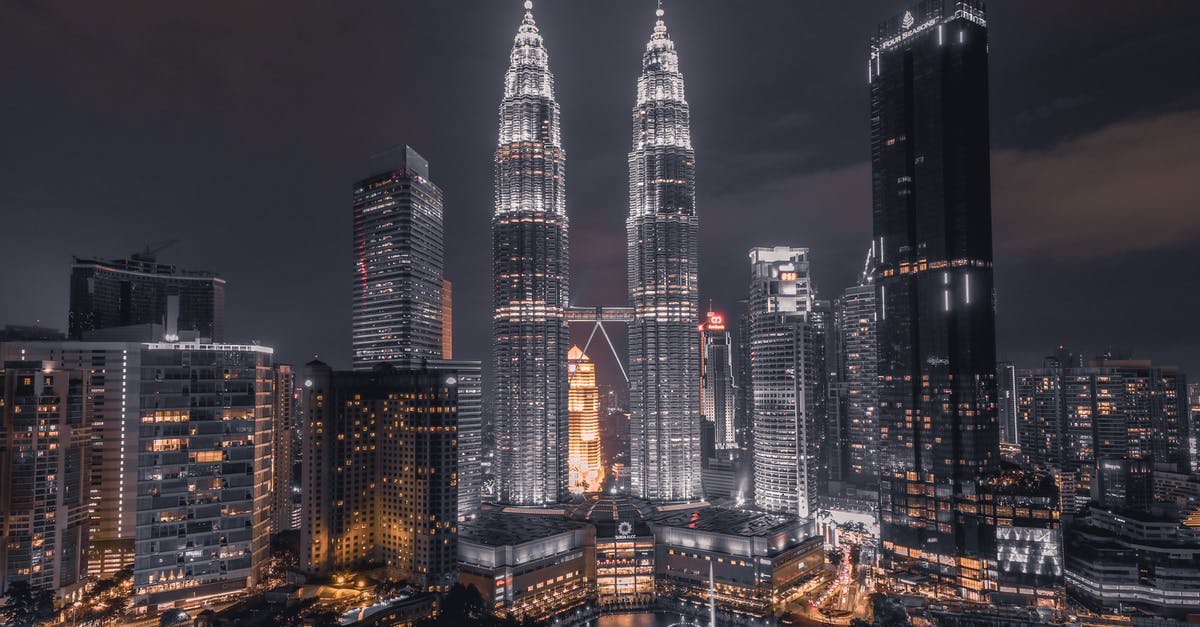 Where is the cityscape in this recent photo, probably in Malaysia? - Scenic View Of City During Evening