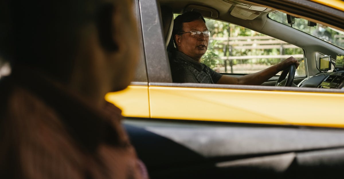 Where is the Gare du Nord taxi station? - Ethnic men communicating in cars on road