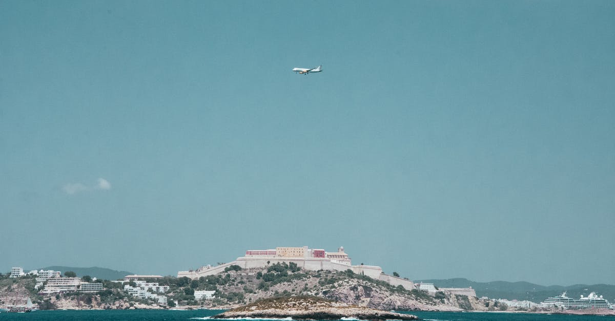 Where is the safest place in an airplane? [duplicate] - White Airplane Flying over a City Under Blue and White Cloudy Sky