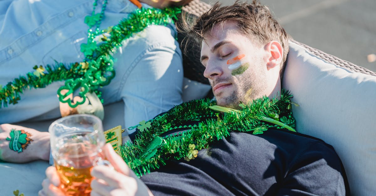 Where is this flag from? [closed] - From above of drunk guy with glass of beer in hands lying on sofa and napping near crop unrecognizable friends after celebrating Feast of Saint Patrick