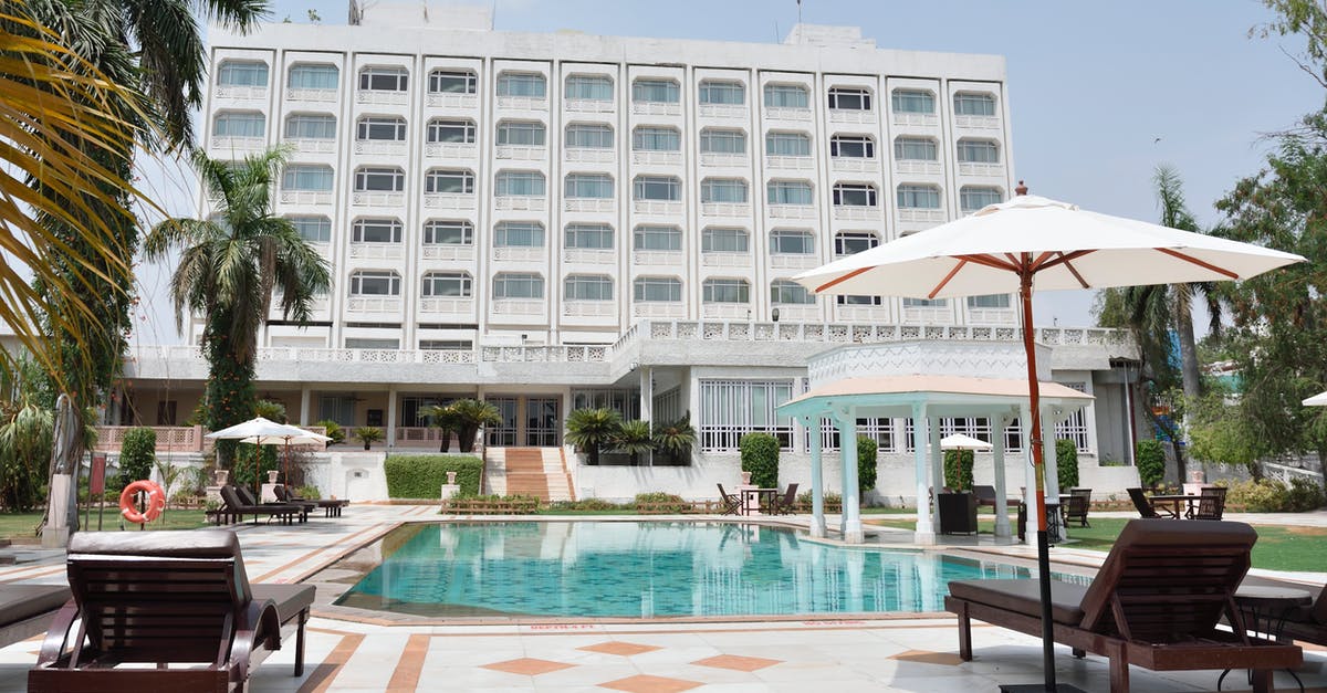 Where is this Indian-style palace with a large pool? - Gray Concrete Swimming Pool Beside White Building