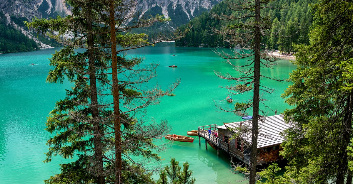 Where is this? (Likely Alpine lake.) - Brown Wooden Dock Near Brown Wooden Kayak in Water