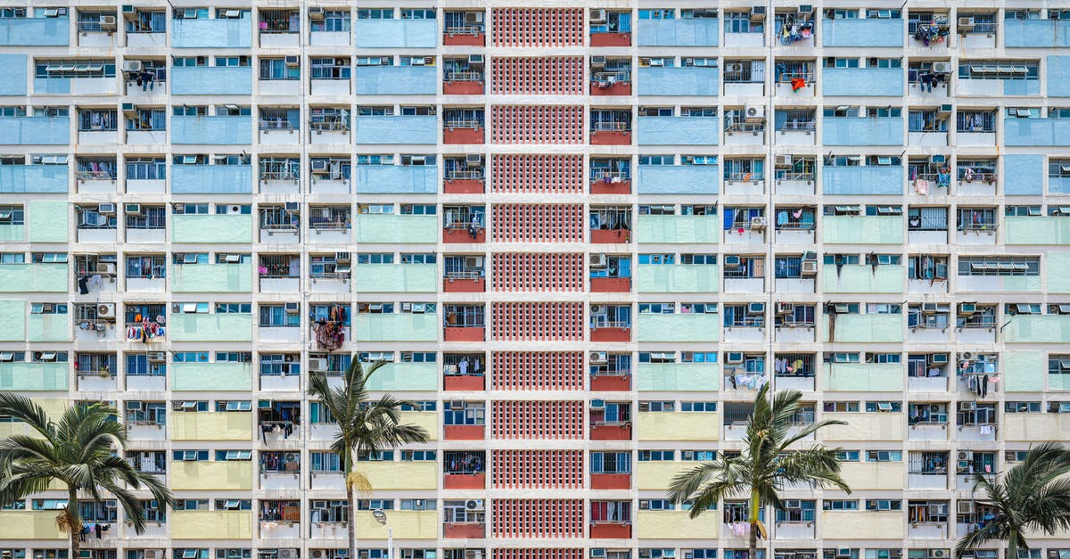 Where is this steeple, these palm trees, flats in Hong Kong? - Multi-colored Building 