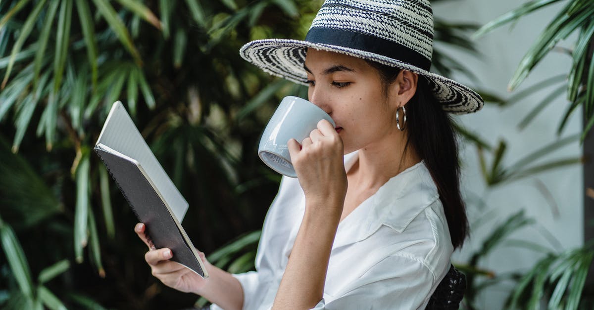 Where near Kagoshima can I visit a tea plantation? - Young ethnic woman reading notebook while drinking beverage on chair