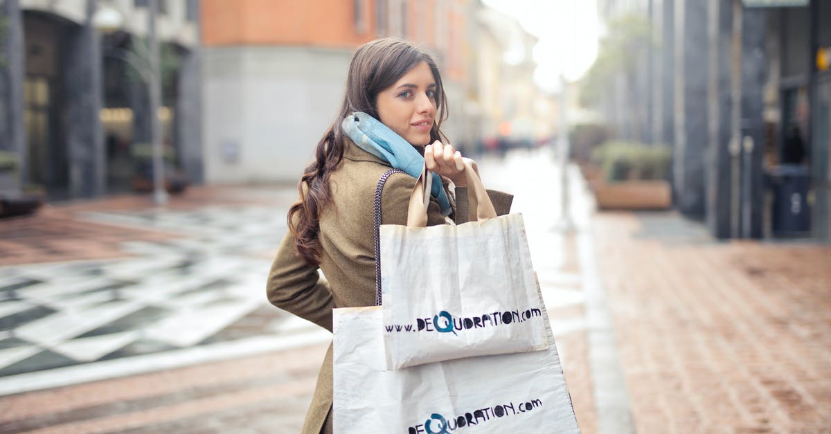 Where to buy winter clothes in Rome , Italy? [closed] - Woman in Brown Coat Carrying Two White Tote Bags