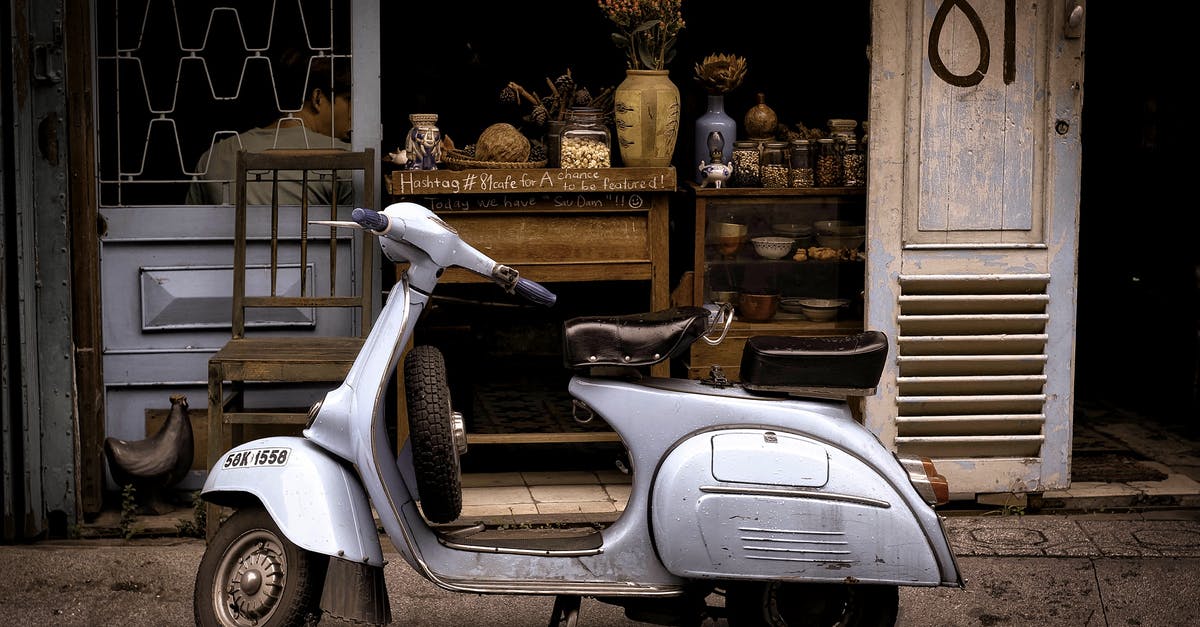 Where to drive an old car in Havana - White and Black Motor Scooter Parked Near Building