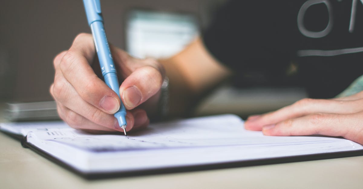 Where to get a list of Kingfisher's cancelled flights? - Person Holding Blue Ballpoint Pen Writing in Notebook