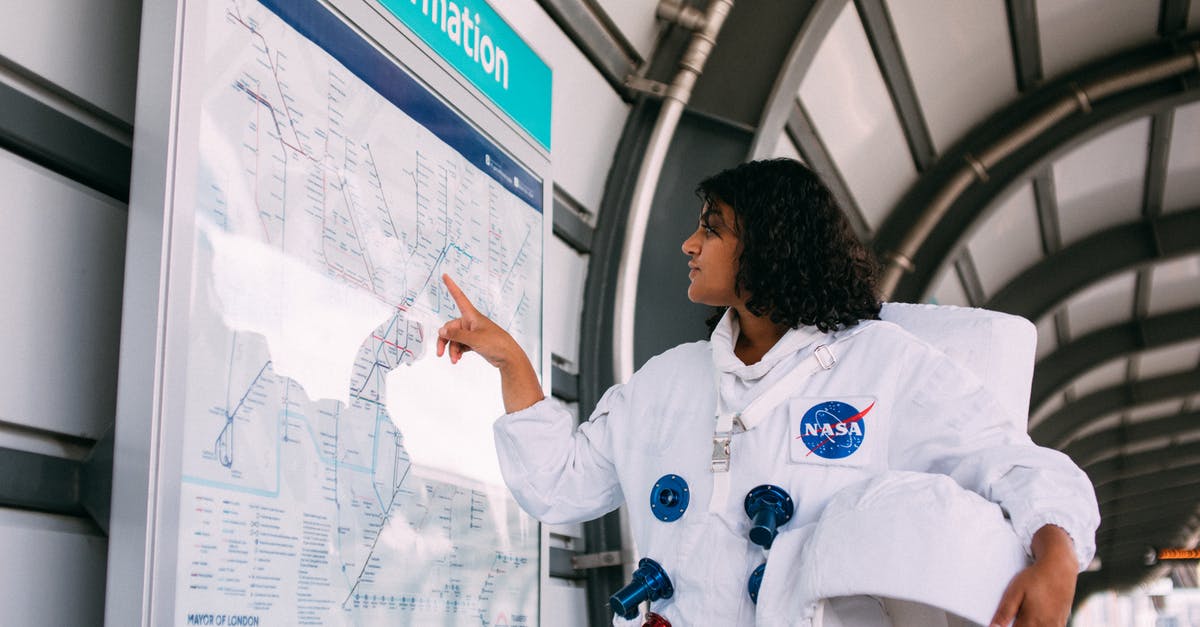 Where to get London rail maps in hardcopy - Woman Wearing A Space Suit At The Train Station