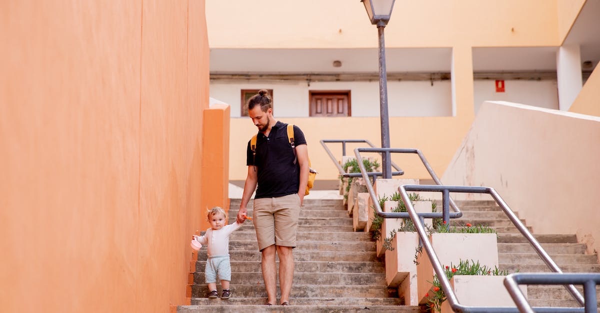 Where to go in Australia when traveling with (small) children - Man and Child Walking Down on Stairs