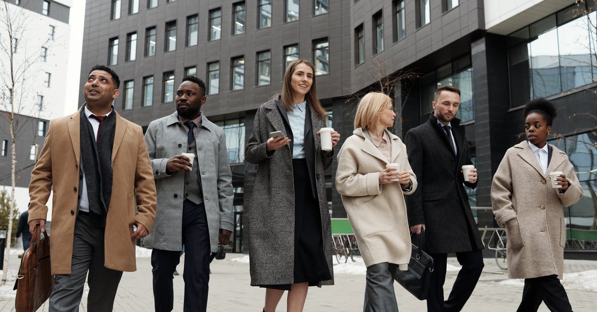 Where to meet outside Heathrow T3? - Coworkers Taking a Coffee Break and Walking