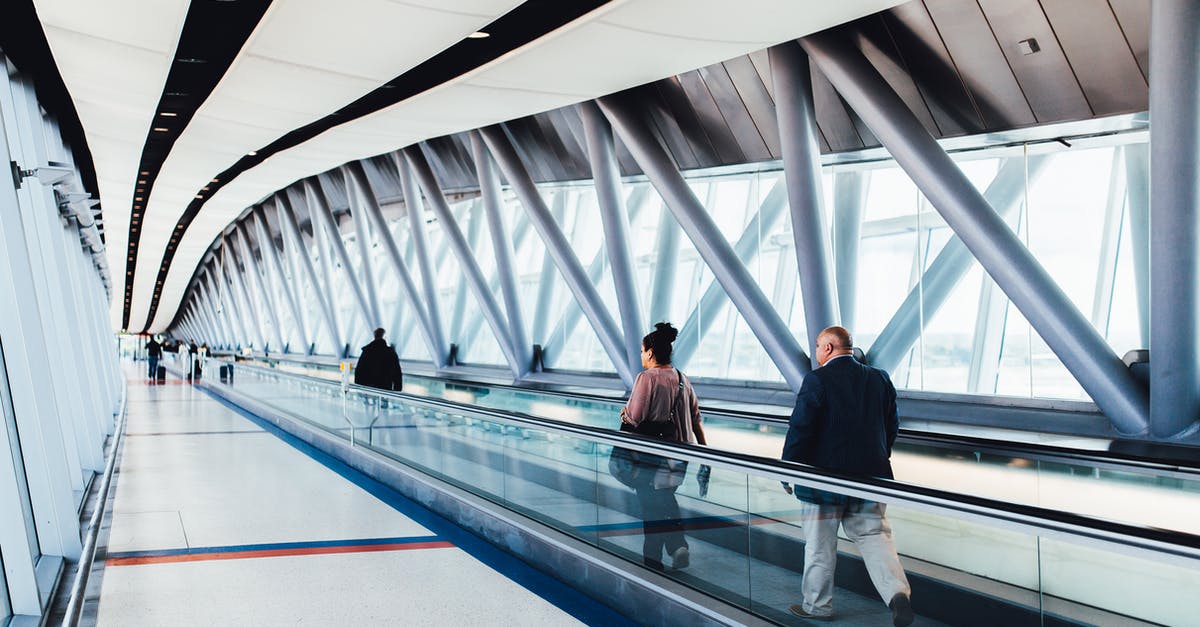 Where to obtain boarding passes when travelling with distinct airlines? - Three Persons Standing on Escalator