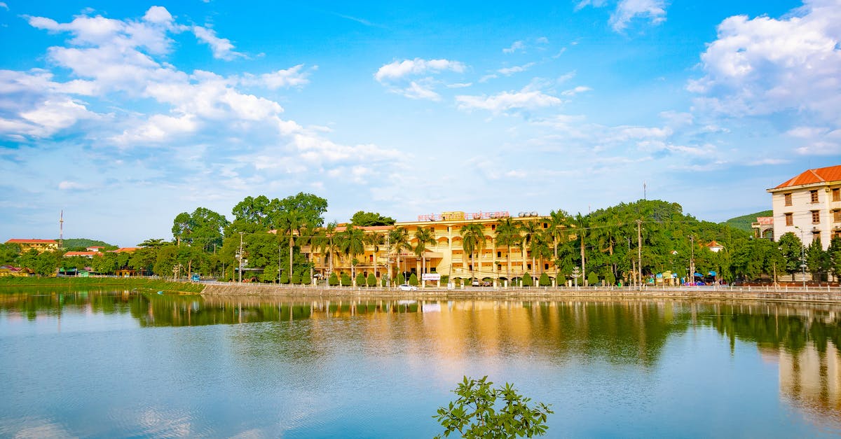 Where to park e-scooters at hotels? - Hotel Building with Green Trees near River