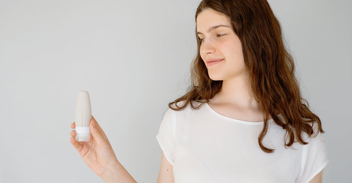 Where to refill my bottle in India? - Woman in White Blouse Holding a Travel Bottle