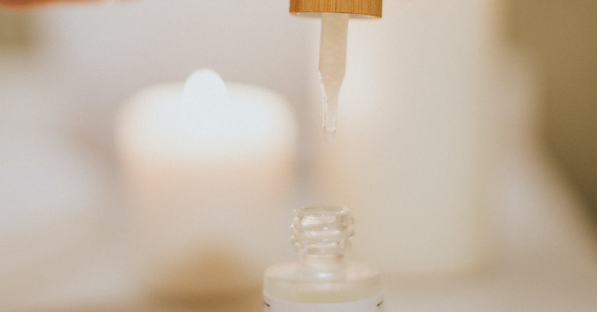 Where to refill my bottle in India? - Person Holding Brown Wooden Stick With White Plastic Bottle