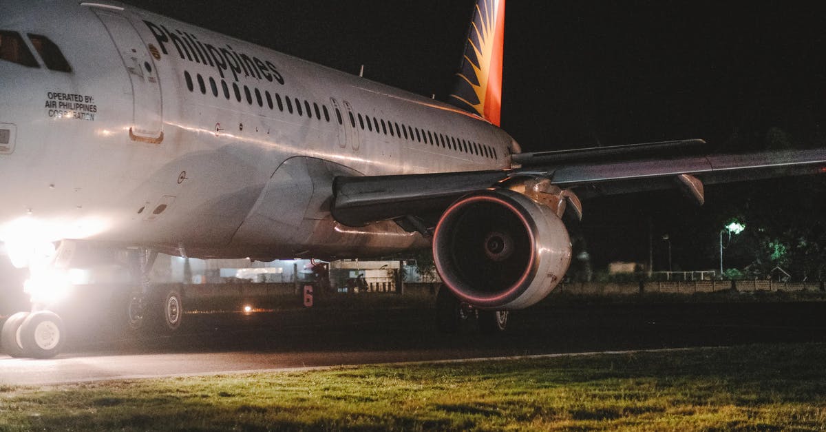 Where to sleep at Frankfurt airport - White and Red Airplane on the Airport during Night Time