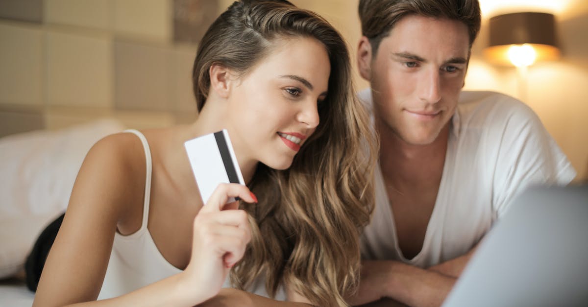Where to store a laptop while doing few days trips during a long-term travel? - Cheerful couple making online purchases at home Where to store a laptop while doing few days trips during a long-term travel? - Cheerful couple making online purchases at home