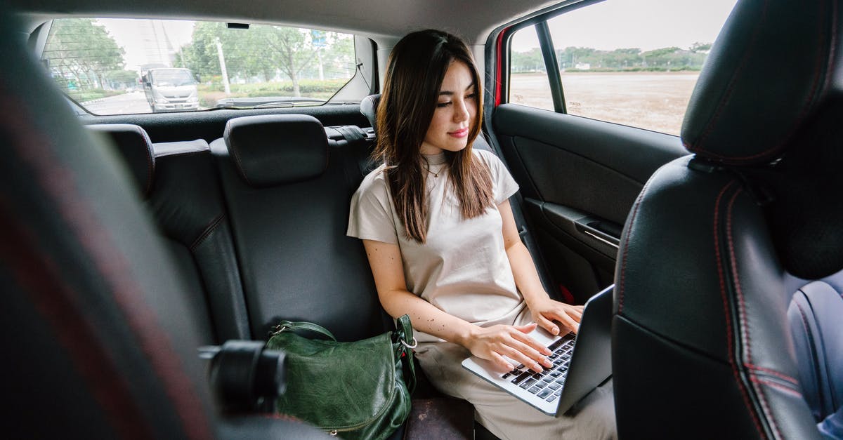 Where to store a laptop while doing few days trips during a long-term travel? - Woman Using Laptop Computer Inside Vehicle Where to store a laptop while doing few days trips during a long-term travel? - Woman Using Laptop Computer Inside Vehicle
