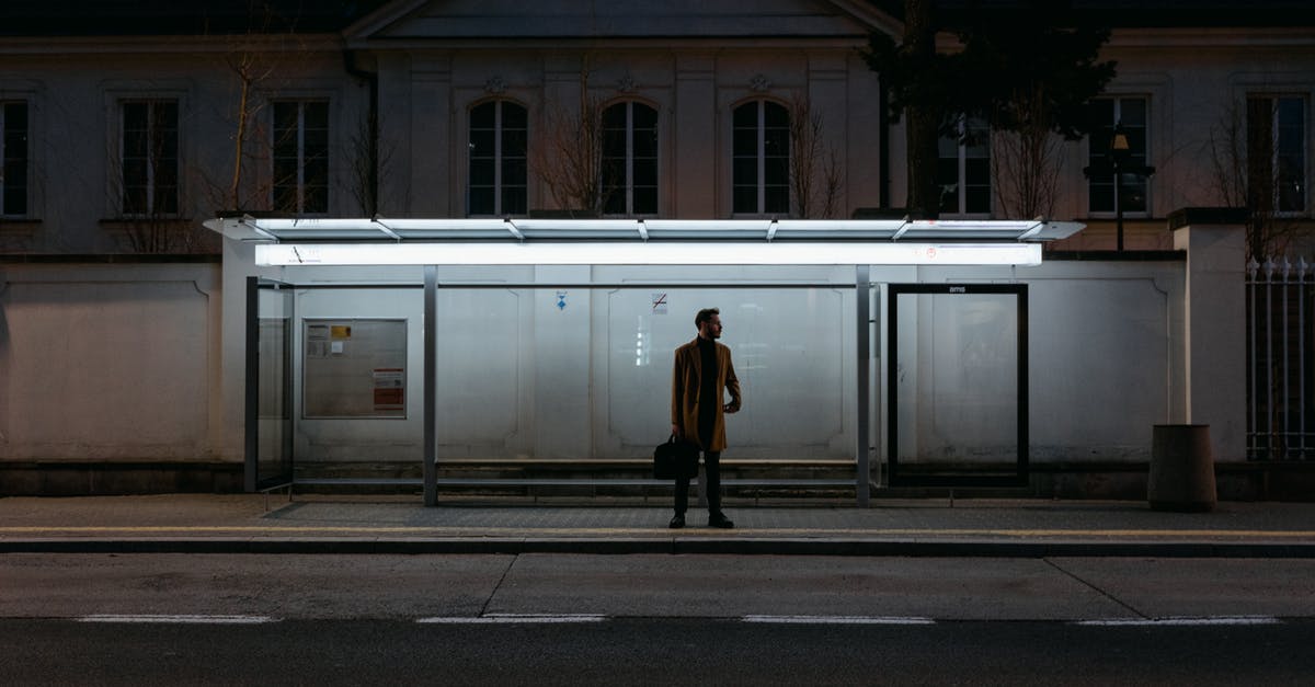 Where to wait in Atlanta in the night? - Silhouette of Man Standing on Platform