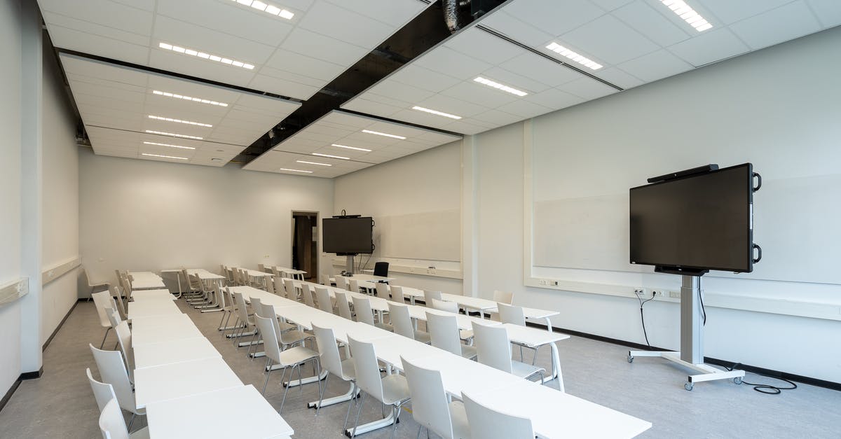 Where was this photograph taken? LG TV Screensaver - White Table and Chairs Inside Room