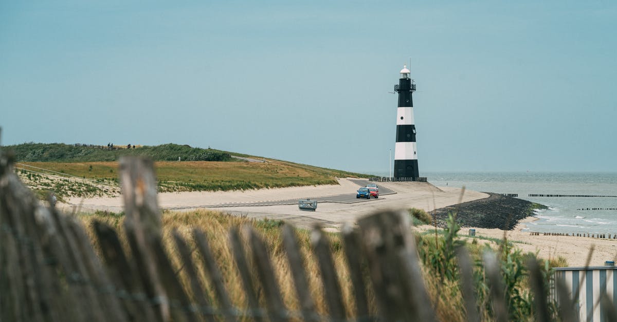 Where was this picture of a seaside road taken? - Solitude lighthouse on coastline at sea