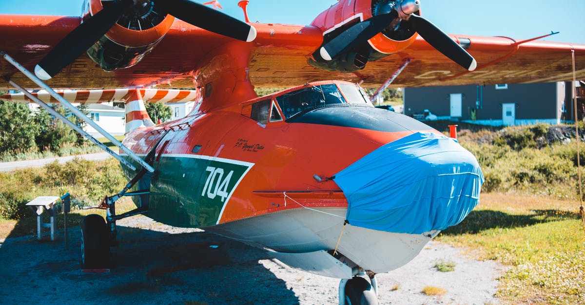 Which airport has direct flights to the most countries? - Modern red airplane parked on airfield