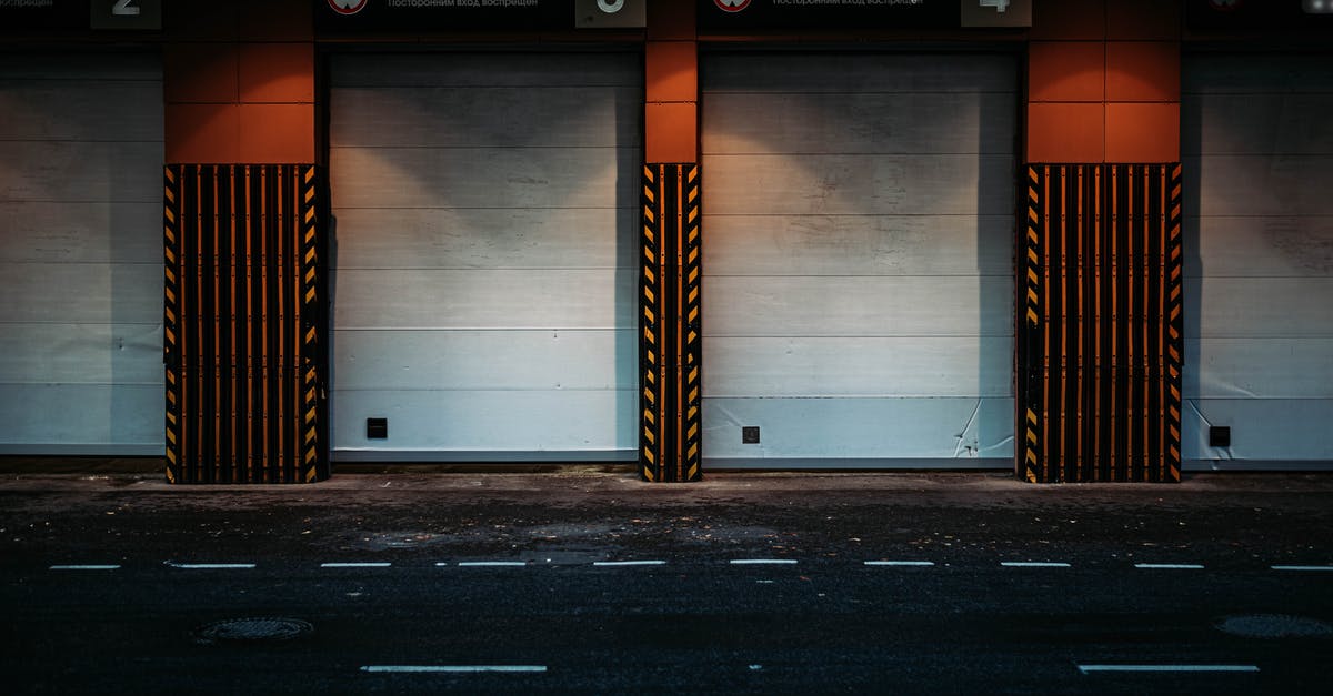 Which building is this? And where is it located? [closed] - Garage gates near road in city