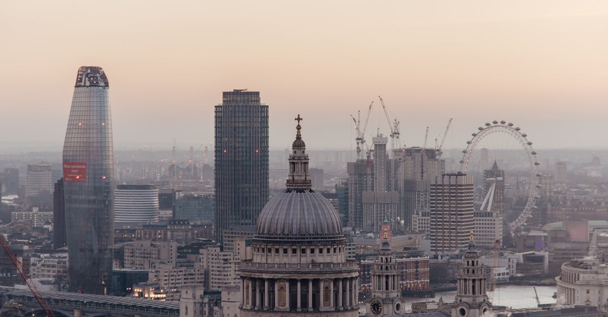 Which buses from London to Continental Europe take the ferry? - Cityscape of London with historic St Pauls cathedral with dome located near modern multistory skyscrapers and famous observation wheel near river