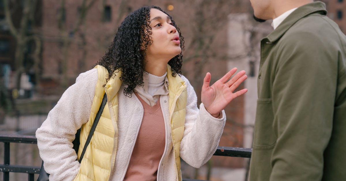 Which cities' transit cards interfere with each other? [closed] - Young stylish Hispanic lady quarreling with crop boyfriend while standing together on city street