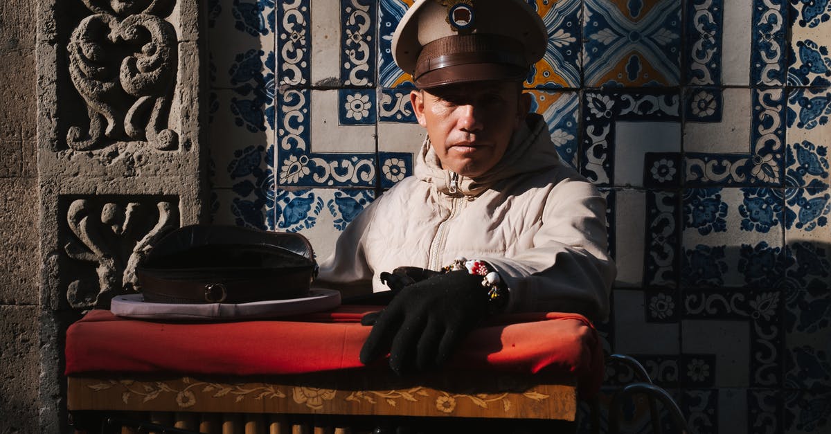 Which cities are connected by direct flights between Mexico and Asia? - Mexican Organillero Man Sitting on the Background of a Patterned Wall