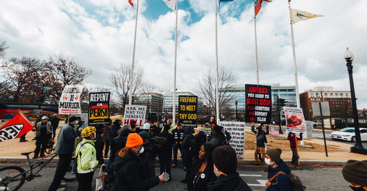 Which city has the greatest religious diversity? [closed] - Unrecognizable multiracial dissenters with placards on city roadway