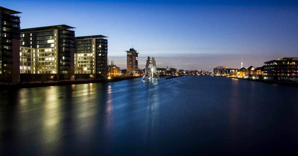 Which European cities are connected by convenient night boat? - Landscape Photo of High Rise Lightning Building Near Body of Water during Night Time