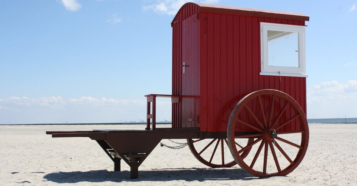 Which ferries to Elba island transport bicycles? - Red and White Cart on Seashore