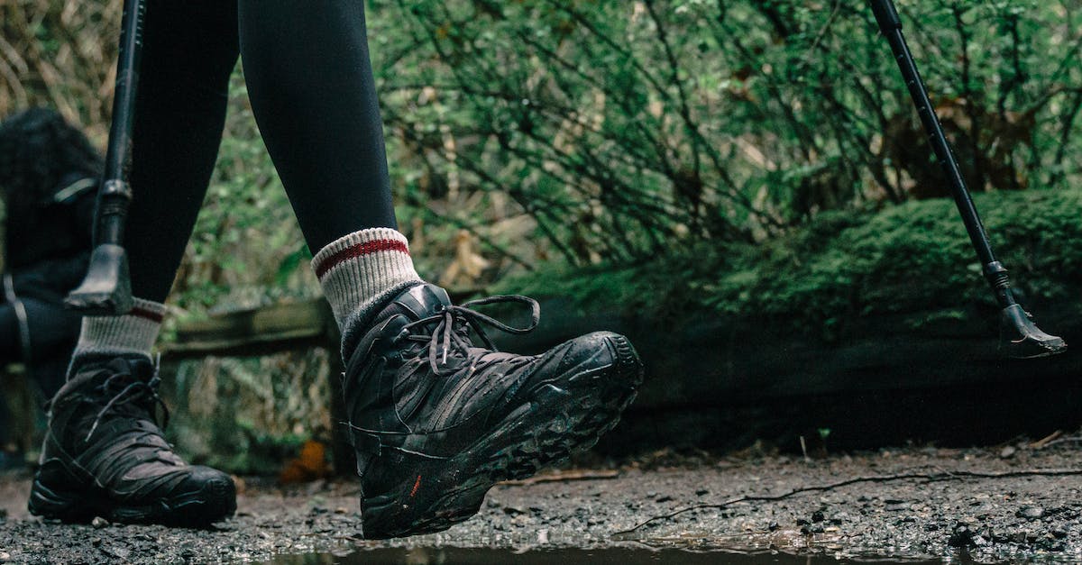 Which places would require hiking boots? - Low-Angle Shot of a Person Wearing Hiking Shoes