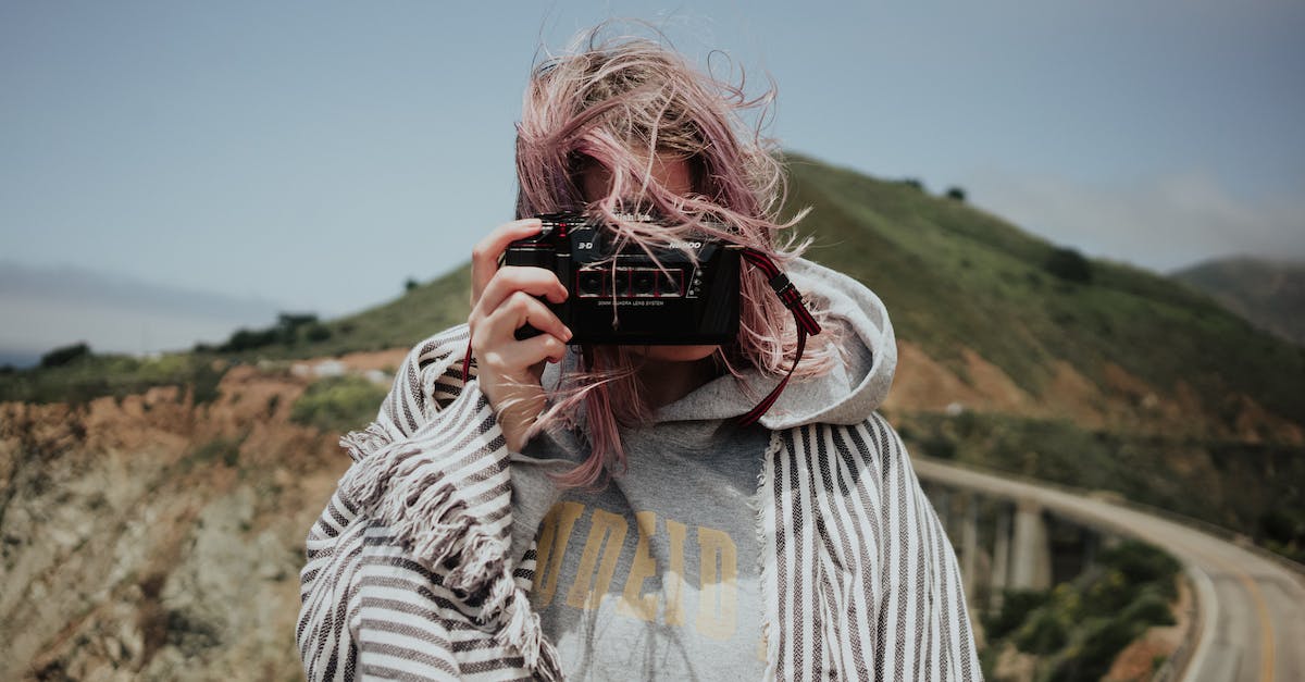 Which scenic road to take to the south of France? - Woman in plaid taking photo in mountains