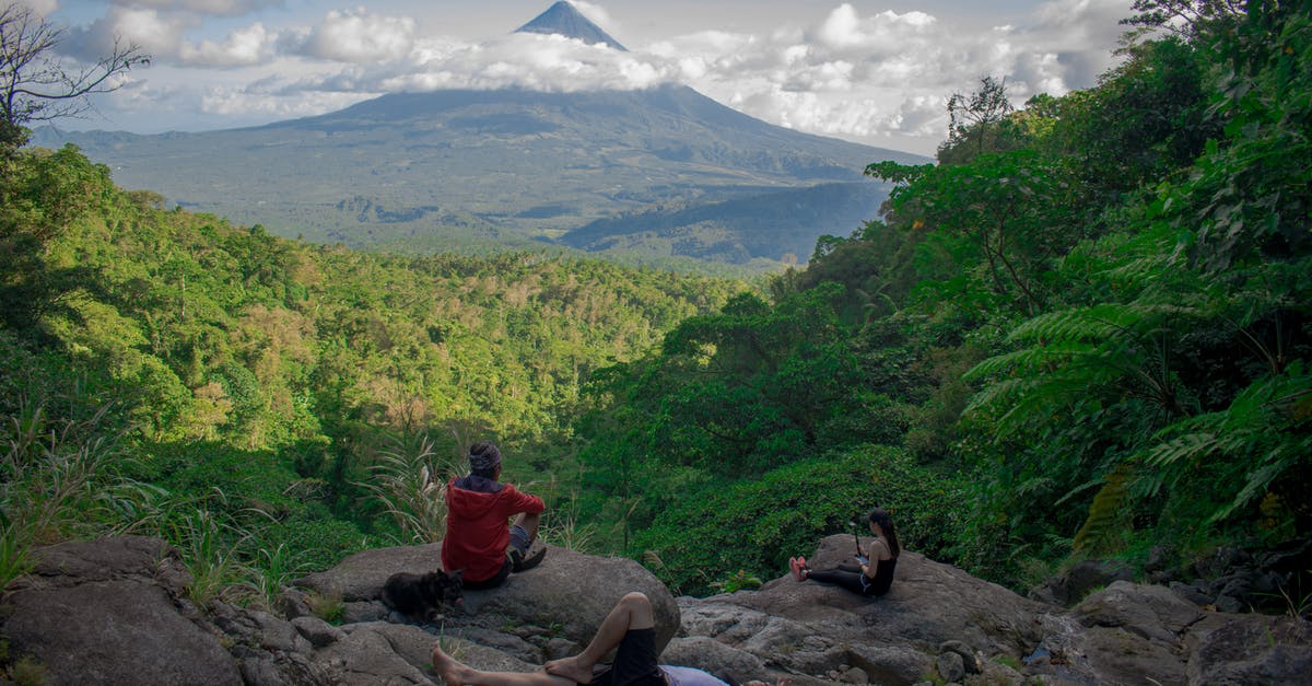 Which volcano is the nearest to Santiago for kids friendly hiking - Photo of Group of People Sitting on Rock Formation
