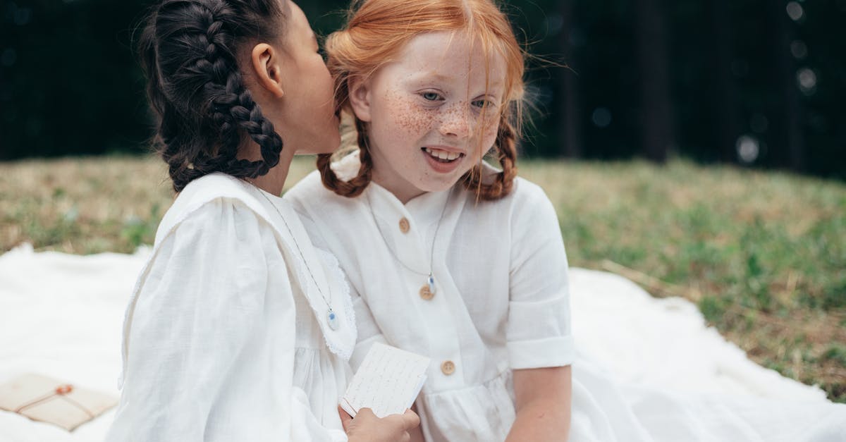 Whispering in other cultures - Girl Whispering to Ear of Friend