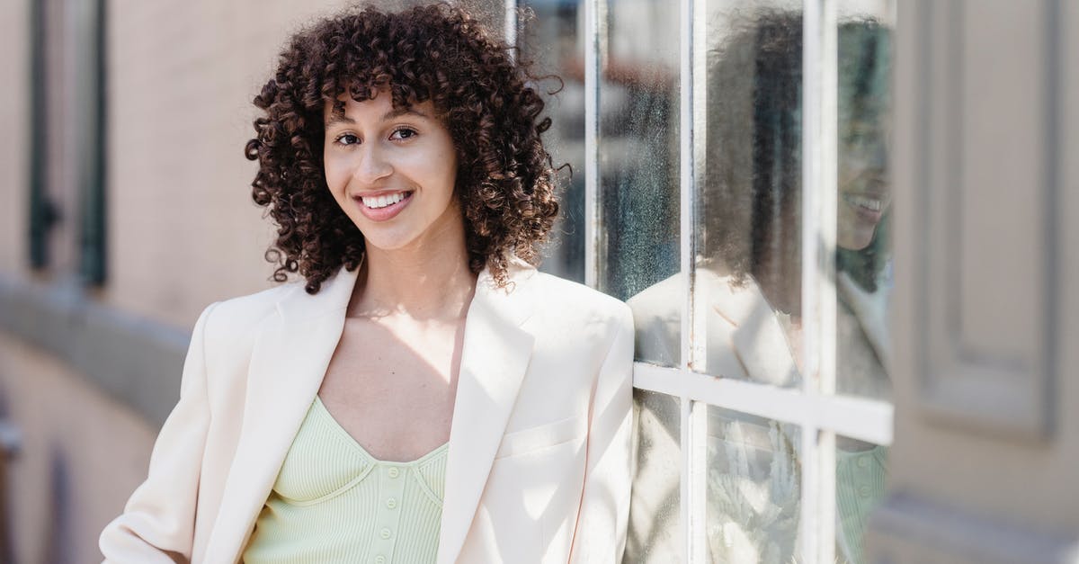 White House tours on weekends? - Happy ethnic woman with curly dark hair smiling on street