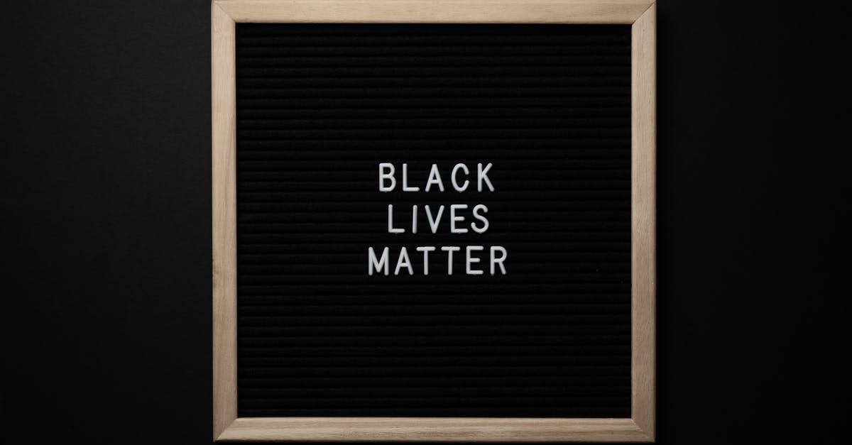 Who is responsible for any change in visa requirements? - Slogan Black Lives Matter on black board