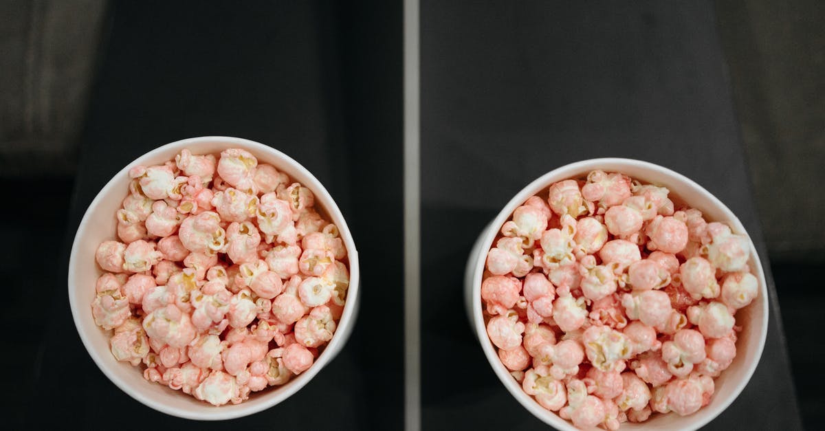 Who owns the middle armrest in airplanes? [closed] - Close Up Shot of Buckets of Popcorn on the Armrest