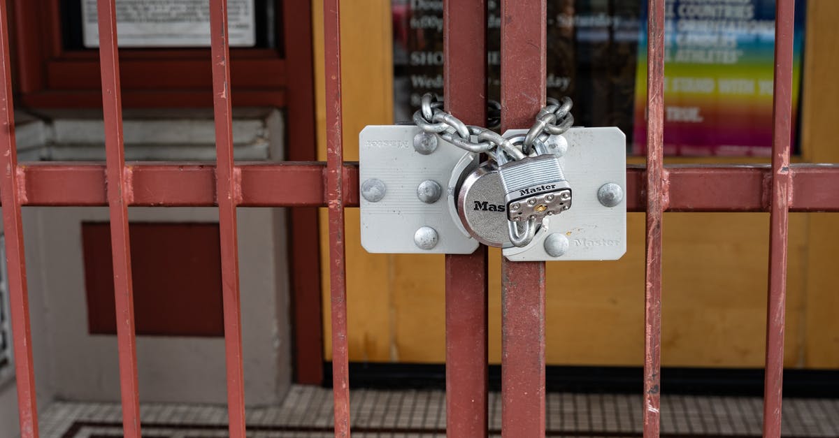 Who works at the International Gate Security check? - Red Metal Gate With Padlock