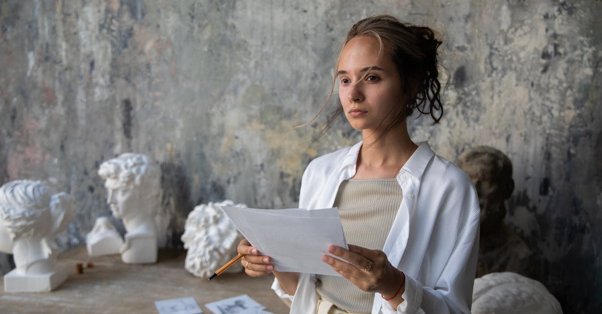 Whom do these Viennese sculptures depict? - Woman in White Long Sleeve Shirt Holding White Printer Paper