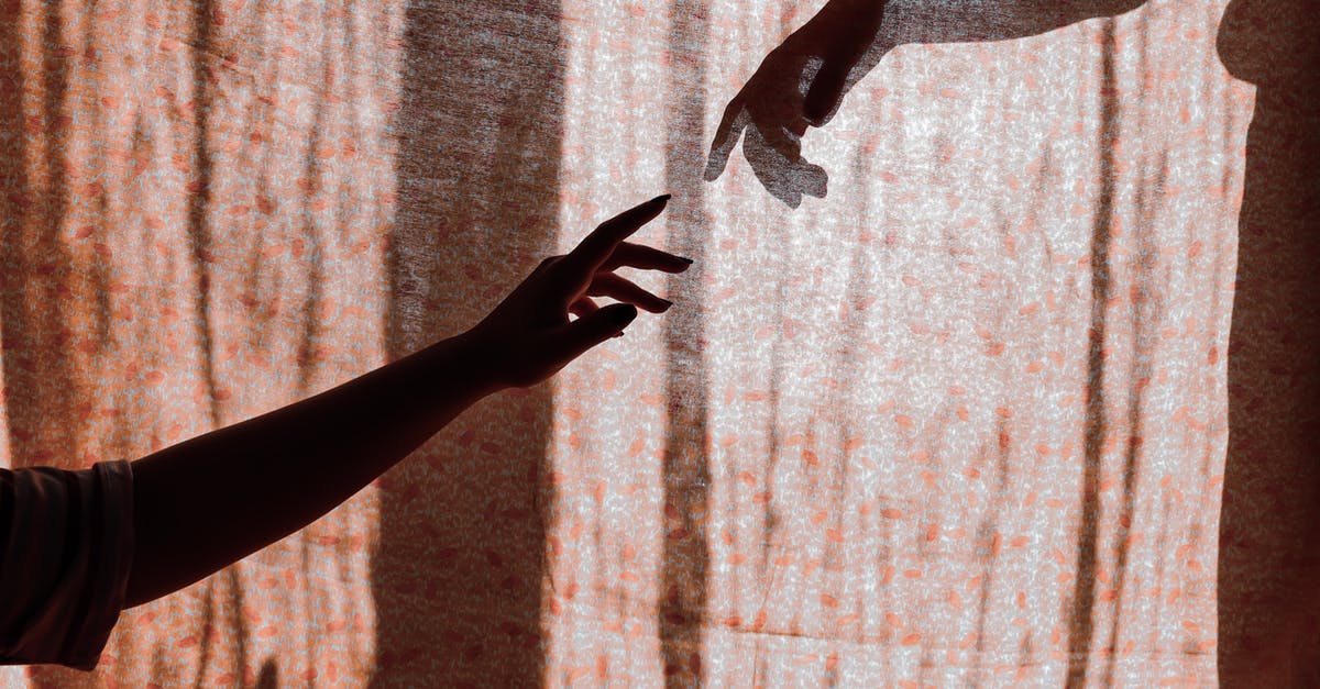 Whom to contact for opting out of a Visa Interview for USA? - Crop unrecognizable man and woman hands reaching out to each other through translucent curtain on sunny day