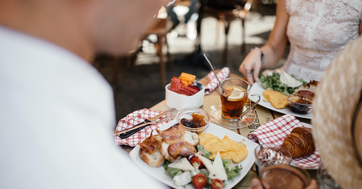 Whose responsibility is update to meal preference? - Woman in White Sleeveless Shirt Sitting on Chair in Front of Table With Foods