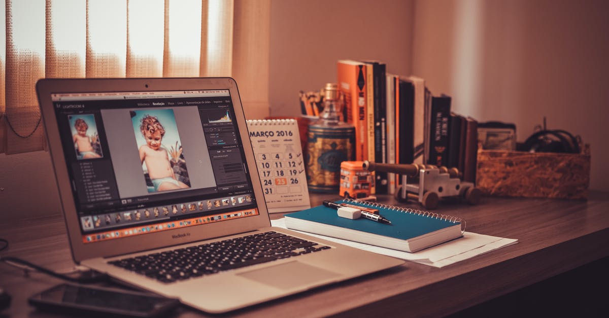 Why 'photoshop' passport photos? - Turned on Screen Silver Macbook Air on Wooden Desk