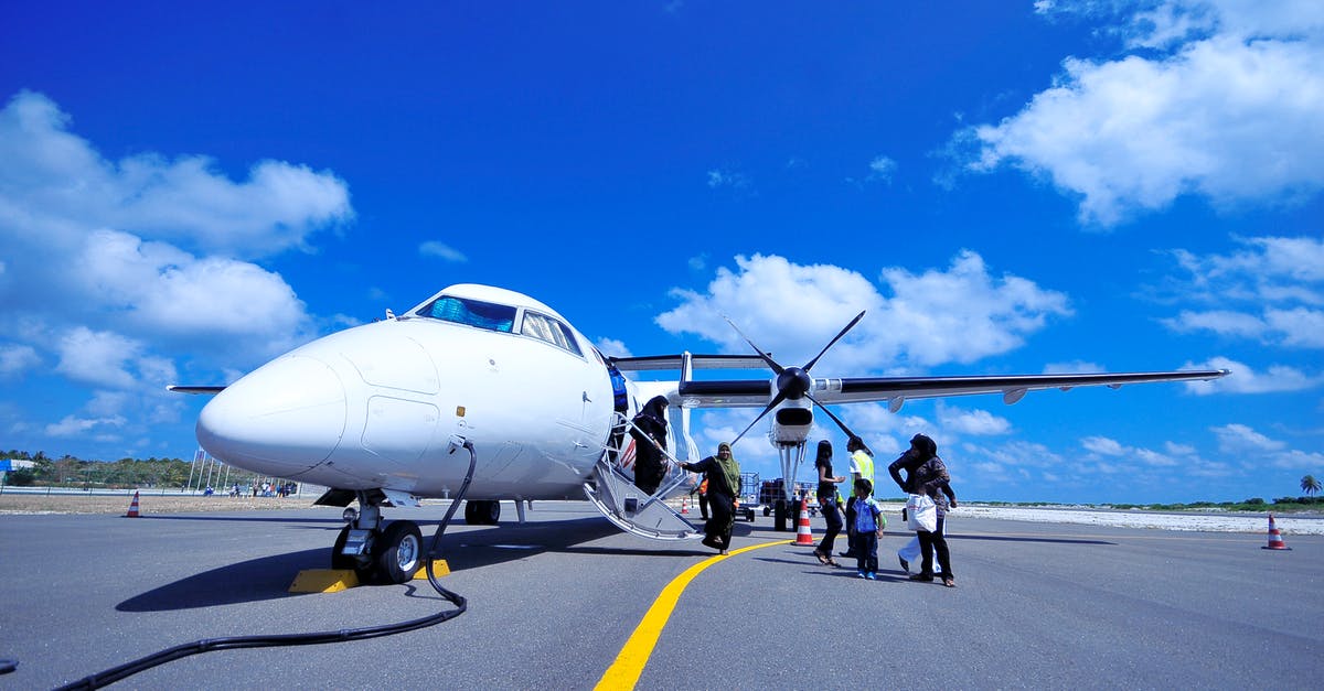 Why are airport wheelchairs often "attendant-propelled" only? - White Jet on Black Tarmac