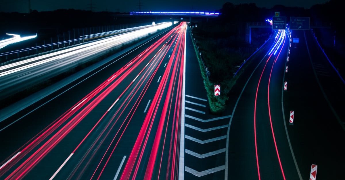 Why are California freeway exits painted with disconnected shoulder lines? - Light Trails on Road at Night